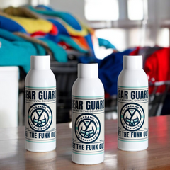 Three bottles of Gear Guard odour removal concentrate displayed side by side on a timber surface, showcasing the mid-sized bundle option. The bottles are uniformly branded with a white bottle. The label has a sky blue border with dark blue writing. The Garame Cleaning Co logo is in the centre, Gear Guard written above and Get the funk out below.