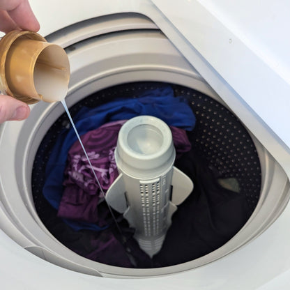 A capful of washing detergent is poured into a washing machine. This shows that Gear Guard works alongside of your existing laundry detergent. 